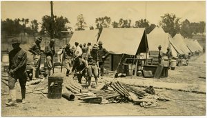 Soldiers Working with Shovels in an Area at the End of a Row of Tents